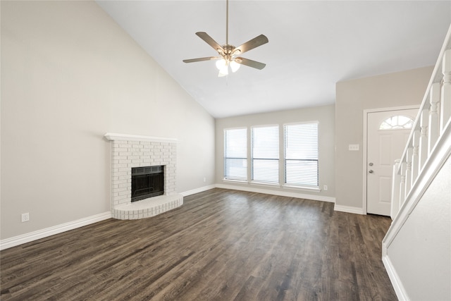 unfurnished living room with high vaulted ceiling, dark hardwood / wood-style floors, a brick fireplace, and ceiling fan