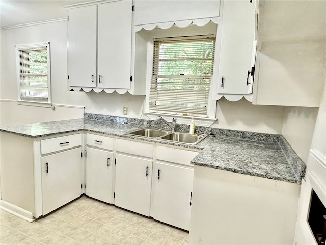 kitchen featuring light tile patterned floors, a wealth of natural light, and sink