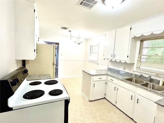 kitchen with white cabinetry, white fridge, sink, stove, and light tile patterned flooring