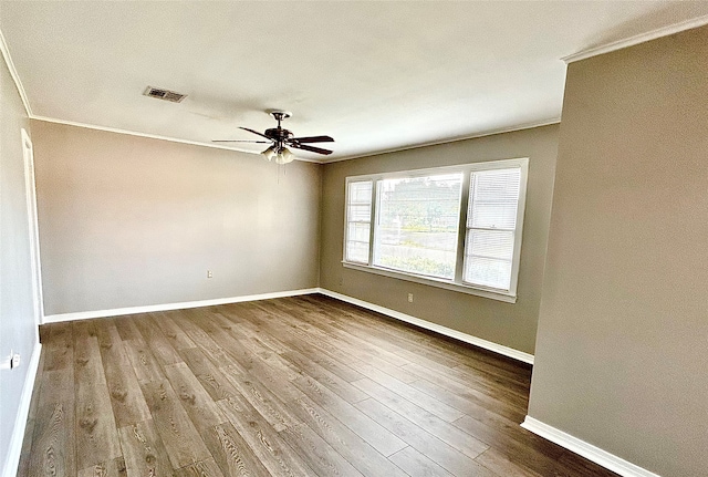 unfurnished room with ceiling fan, hardwood / wood-style floors, and ornamental molding