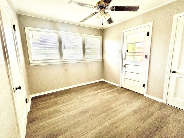 interior space with light hardwood / wood-style floors, crown molding, and ceiling fan