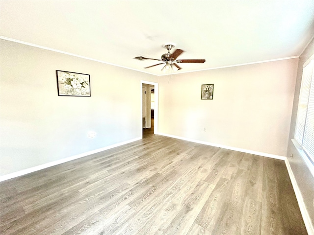 unfurnished room featuring ceiling fan, crown molding, and light wood-type flooring