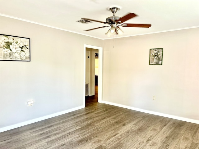 empty room with ceiling fan, hardwood / wood-style flooring, and crown molding