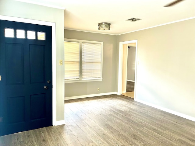 foyer featuring hardwood / wood-style floors and ornamental molding