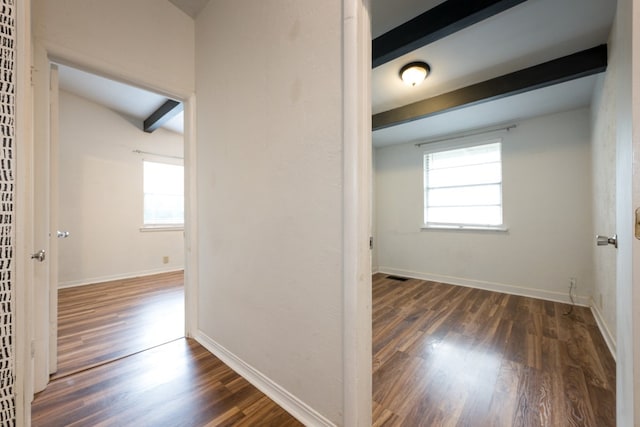 hall with beamed ceiling and dark hardwood / wood-style floors