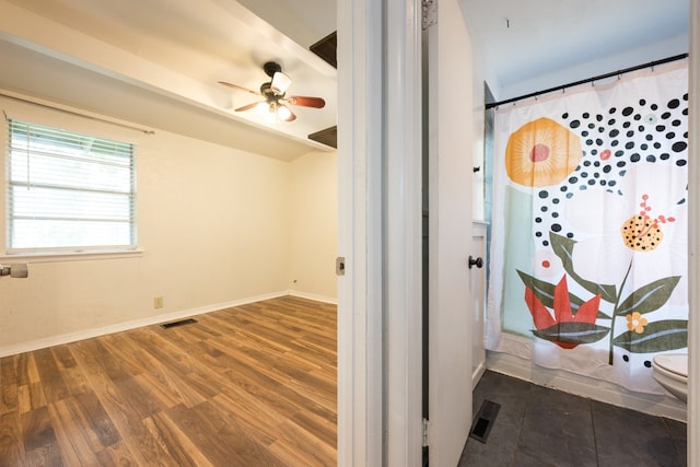 bathroom with toilet, hardwood / wood-style floors, and ceiling fan