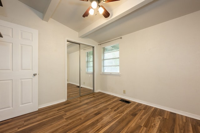 unfurnished bedroom with lofted ceiling with beams, dark hardwood / wood-style floors, a closet, and ceiling fan