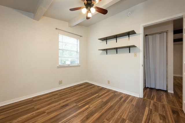 spare room with beam ceiling, dark wood-type flooring, and ceiling fan