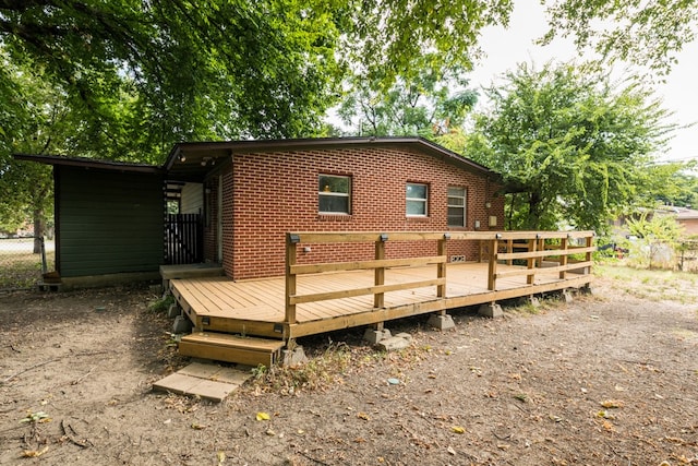 rear view of property featuring a wooden deck