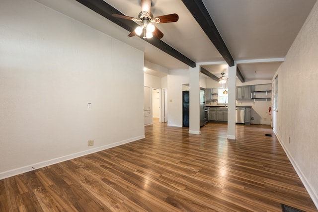 unfurnished living room with dark wood-type flooring, lofted ceiling with beams, and ceiling fan