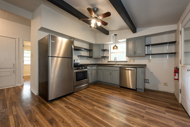 kitchen with dark hardwood / wood-style flooring, appliances with stainless steel finishes, ceiling fan, gray cabinetry, and lofted ceiling with beams