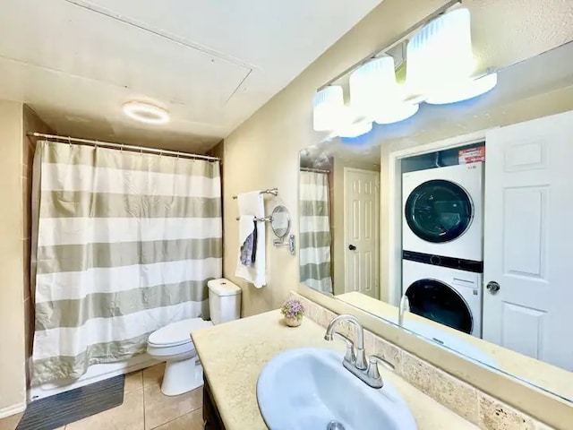 bathroom with vanity, tile patterned flooring, stacked washer / drying machine, curtained shower, and toilet