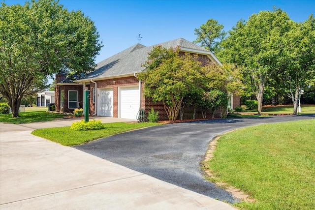 view of front of property featuring a garage and a front yard