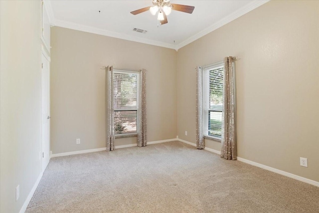 carpeted spare room featuring ceiling fan and ornamental molding