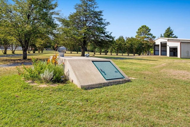 view of storm shelter featuring a lawn and an outdoor structure