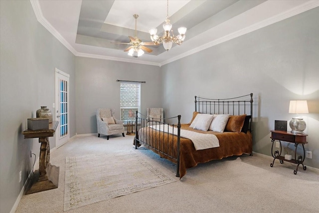 carpeted bedroom featuring a tray ceiling, crown molding, and a notable chandelier