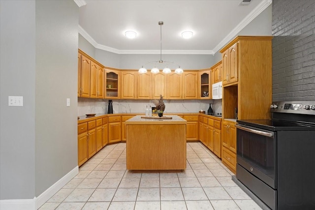 kitchen with electric range, light tile patterned floors, brick wall, crown molding, and a kitchen island