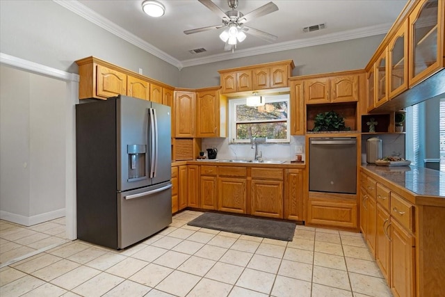 kitchen featuring backsplash, sink, ornamental molding, appliances with stainless steel finishes, and light tile patterned flooring