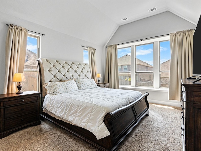 bedroom with carpet floors, visible vents, and vaulted ceiling