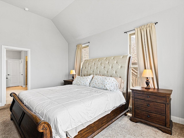 carpeted bedroom featuring vaulted ceiling and baseboards