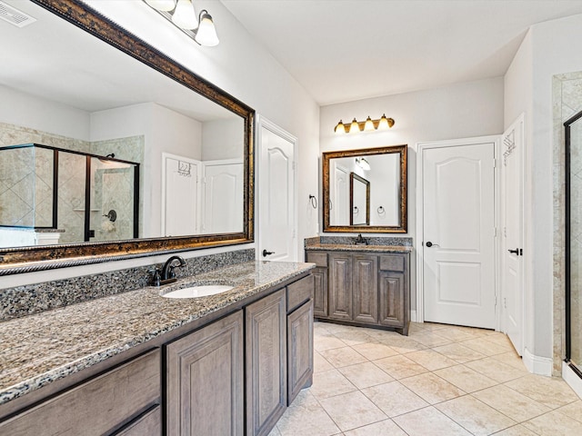 bathroom featuring two vanities, visible vents, a sink, and a shower stall