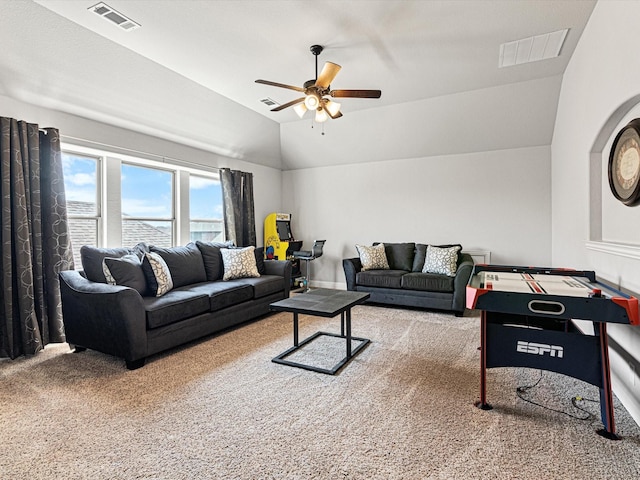 carpeted living area featuring a ceiling fan, visible vents, and vaulted ceiling