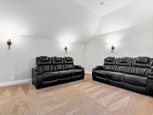 carpeted home theater featuring vaulted ceiling, visible vents, and baseboards