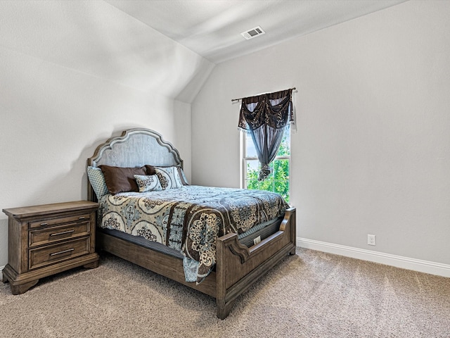 bedroom featuring lofted ceiling, visible vents, light carpet, and baseboards