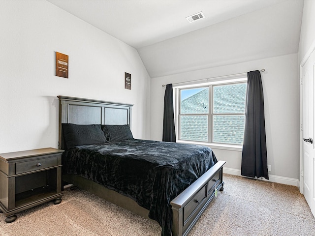 bedroom featuring lofted ceiling, baseboards, visible vents, and carpet flooring