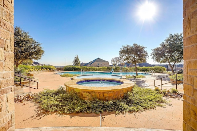 community pool with a hot tub