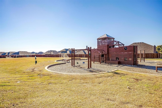 community play area with a yard and fence