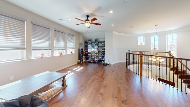 interior space with ceiling fan, plenty of natural light, and wood-type flooring