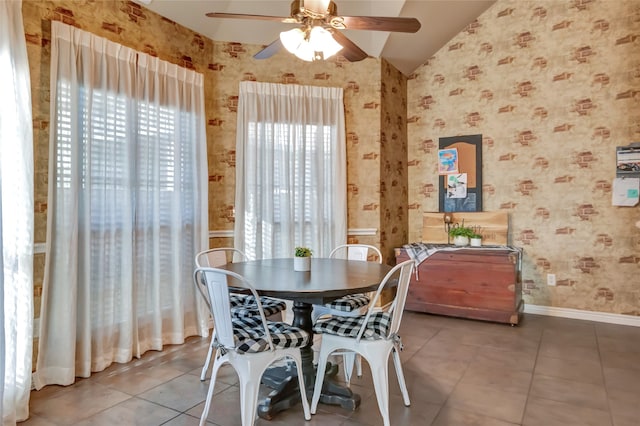 dining space with vaulted ceiling, baseboards, and wallpapered walls