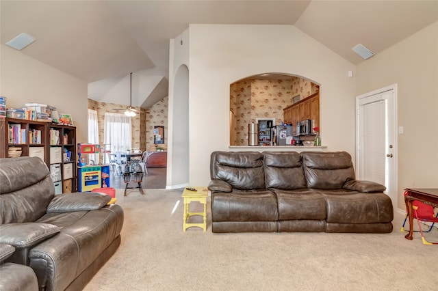 living room featuring light carpet and vaulted ceiling