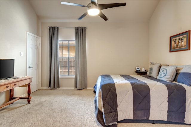 carpeted bedroom with a ceiling fan and baseboards