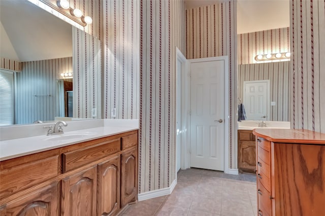 bathroom with vanity, lofted ceiling, and tile patterned floors