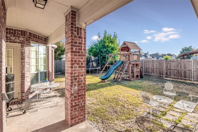 view of yard with a playground and a patio area