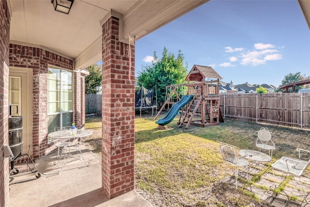 exterior space featuring a patio area, a fenced backyard, a trampoline, and a yard