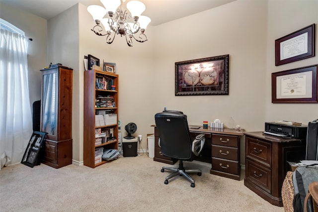 carpeted home office featuring a chandelier