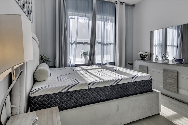 bedroom featuring light hardwood / wood-style floors and multiple windows