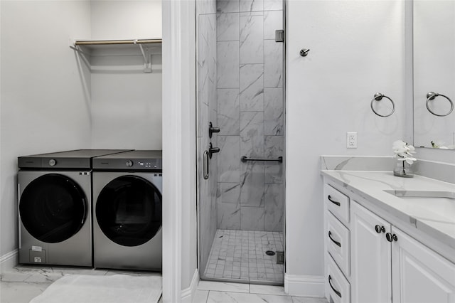 laundry room featuring washing machine and clothes dryer and light tile patterned floors