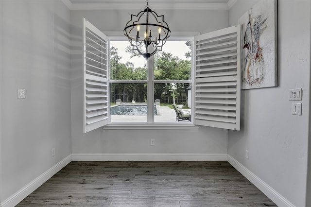 unfurnished dining area featuring a notable chandelier, plenty of natural light, and wood-type flooring