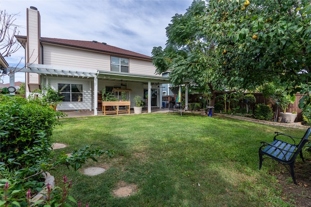 back of house with a lawn and a patio area