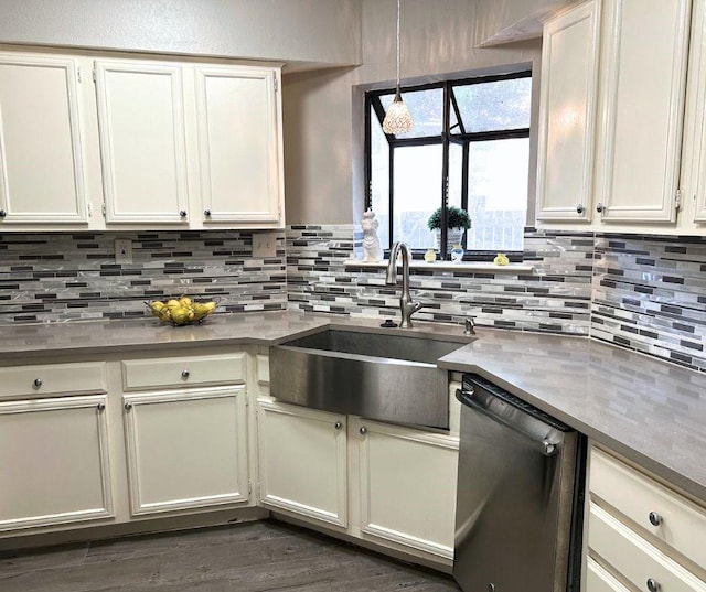 kitchen featuring sink, decorative backsplash, white cabinets, and dishwasher