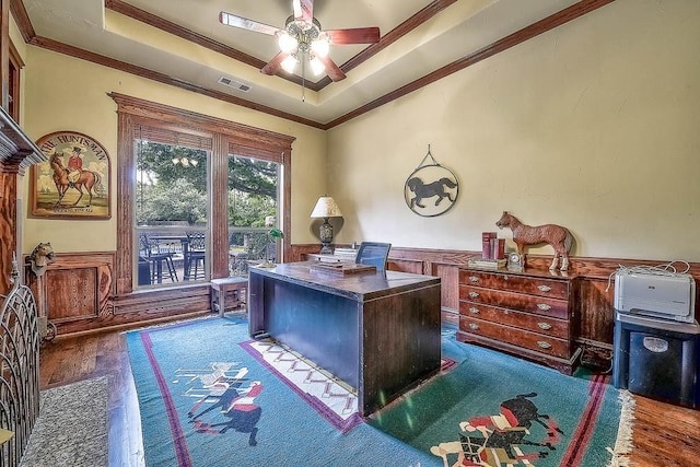 office featuring crown molding, a raised ceiling, visible vents, dark wood-type flooring, and wainscoting