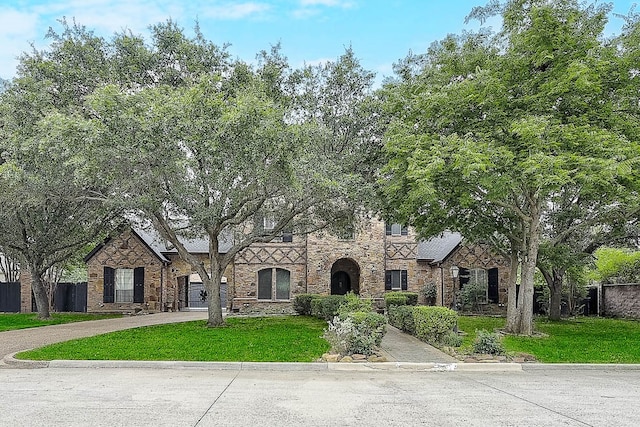 tudor house featuring a front yard