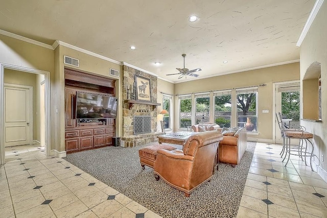 living room with a stone fireplace, visible vents, and a healthy amount of sunlight