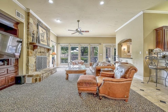 living area featuring arched walkways, a fireplace, visible vents, ornamental molding, and baseboards