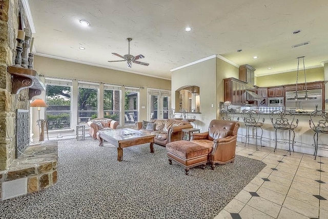 living room featuring a ceiling fan, recessed lighting, visible vents, and crown molding