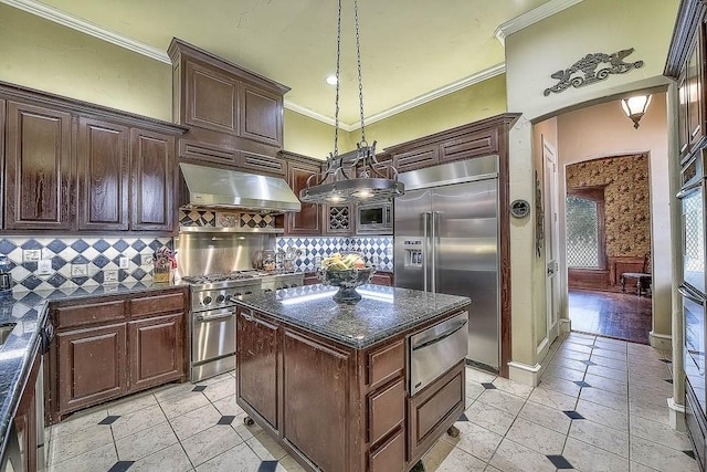 kitchen with built in appliances, a kitchen island, exhaust hood, hanging light fixtures, and a warming drawer